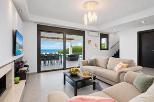 a living room with a couch and a table at Villa Metis in Lachania