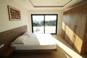 a bedroom with a large bed and a large window at Villa Solis in Novalja +88 photos