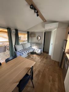 a living room with a couch and a table at MA105 Le Mazet in Vias