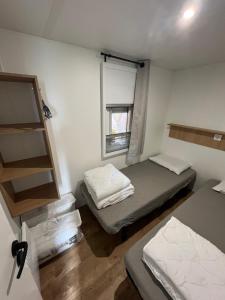 a small room with two beds and a window at MA105 Le Mazet in Vias +7 photos