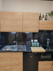 a kitchen with a sink and a counter top at Ta'Roza Modern Apartment with Balcony & Distant Sea Views - Xaghra Gozo in Xagħra +11 photos