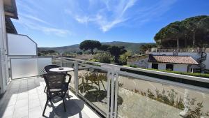a balcony with a chair and a view of the mountains at Hotel Villa Smeraldo in Orbetello