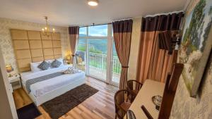 a bedroom with a bed and a large window at Hotel Bonavista in Nuwara Eliya