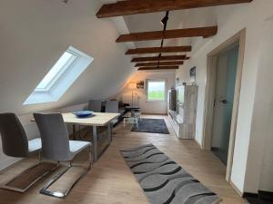 a kitchen and dining room with a table and chairs at Huus Diekblick Ditzum in Bunde