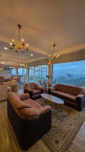 a large living room with couches and a chandelier at Hotel Bonavista in Nuwara Eliya
