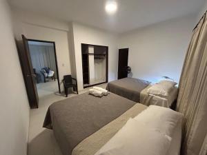 a hotel room with two beds and a mirror at Apartamento 201 amplio cómodo in Cali