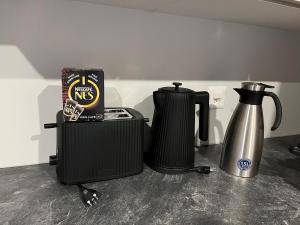 a coffee maker and a kettle on a counter at Appartement entier dans chalet traditionnel in Bratsch
