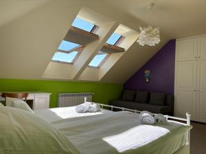 a bedroom with two beds with towels on them at Mirabelka Mucharz in Mucharz