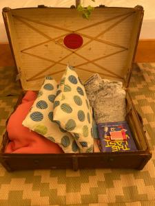 a wooden box with two pillows and a toy at Nine Acres, Hot Tub, peaceful in Brackley