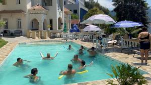 a group of people in a swimming pool at Casa das Luzes Hostel IVN in Rio de Janeiro