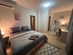 a bedroom with a bed with two towels on it at House Varna-4 in Krapets