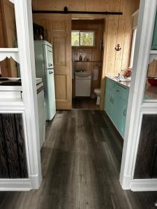 a kitchen with green appliances and a wooden floor at Chalets Memphrémagog in Magog-Orford +2 photos