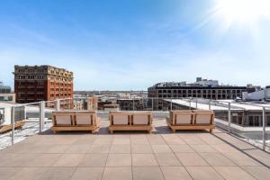 a balcony with chairs and a view of a city at Bresoles Hotel in Montreal