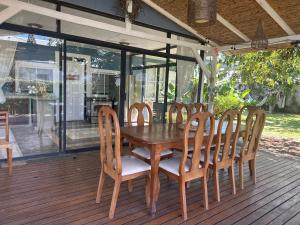 a wooden table and chairs on a deck at CASA STELLA in Heredia