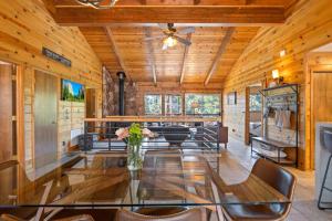 a dining room with a glass table and chairs at Enchanted Pines in Twain Harte