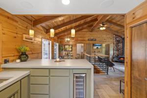a kitchen with wooden walls and a ceiling with beams at Enchanted Pines in Twain Harte +15 photos