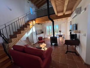 a living room with a couch and a staircase at Marvão Country Houses - Queixos II in Santo António das Areias