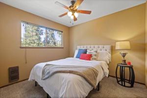 a bedroom with a bed with a ceiling fan at Enchanted Pines in Twain Harte