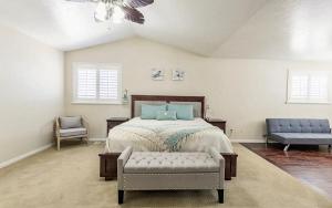 a bedroom with a bed and a couch and a chair at Fossil Crest Retreat in Vernal