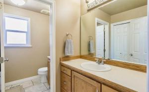 a bathroom with a sink and a toilet and a mirror at Fossil Crest Retreat in Vernal +26 photos