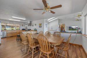 a kitchen and dining room with a wooden table and chairs at Hidden Views Cabin in Twain Harte