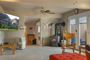 a living room with a fireplace and a stove at Hidden Views Cabin in Twain Harte