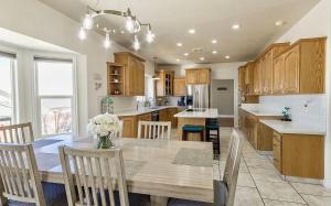 a kitchen with a wooden table with chairs and a vase of flowers at Fossil Crest Retreat in Vernal