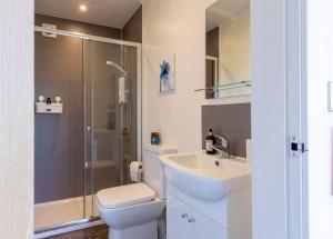 a bathroom with a toilet and a sink and a shower at Hare Hill - Dog Friendly in Penicuik