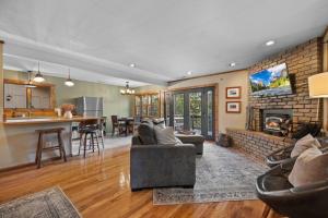 a living room with a couch and a fireplace at Hot Tub - Huge Deck - Lake Access in Twain Harte +10 photos
