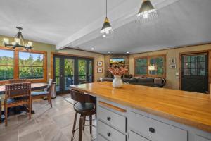 a kitchen and living room with a table and chairs at Hot Tub - Huge Deck - Lake Access in Twain Harte