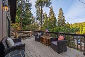 a patio with two chairs and a table on a deck at Hot Tub - Huge Deck - Lake Access in Twain Harte