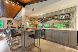 a kitchen with a bar with bar stools at Chic Modern Glam in Rockford