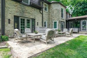 a patio with chairs and a table on a lawn at Chic Modern Glam in Rockford +45 photos