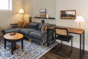 a living room with a couch and a table at Downtown Luxe 2BR Loft Apt | Prime Location | Sleeps 10 in Milwaukee