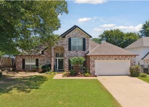 a brick house with a white garage at The Tulsacation 2 in Tulsa