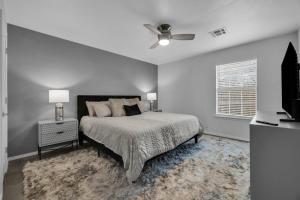 a bedroom with a bed and a ceiling fan at The Tulsacation 2 in Tulsa