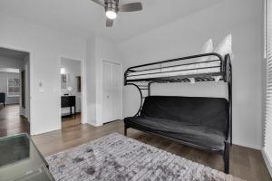 a bedroom with a bunk bed and a living room at The Tulsacation 2 in Tulsa +27 photos
