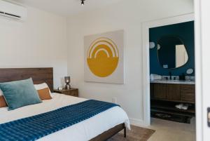a bedroom with a bed and a bathroom with a mirror at Camp Cold Springs in Concan +23 photos