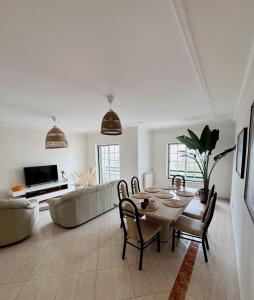 a living room with a table and a couch at The Salty Nap in Ericeira