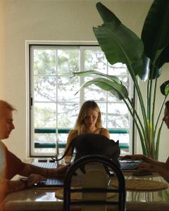 a group of people sitting at a table with a laptop at The Salty Nap in Ericeira
