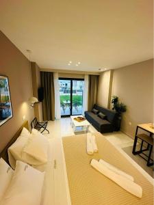 a large living room with a couch and a table at Sithonian Sunset Luxury Apartments in Skála Nikíta