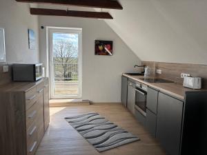 a kitchen with a sink and a stove top oven at Huus Diekblick Ditzum in Bunde