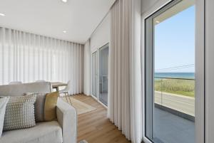 a living room with a couch and a large window at Atlantic Apartments in Santa Cruz