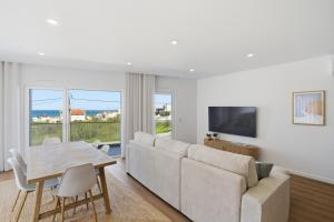 a living room with a couch and a table and a television at Atlantic Apartments in Santa Cruz