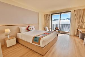 a bedroom with a large bed and a balcony at Sapa Lumia Hotel in Sapa +105 photos