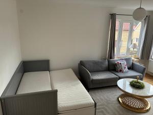 a living room with a couch and a table at Ruddbecksgatan AA in Eskilstuna