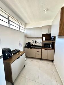 a kitchen with a counter and a sink in it at CasaMara in Ribeirão Preto