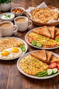 a table topped with plates of food with eggs and toast at Luxury Private Room Canal Rd Near Galleria in Faisalabad