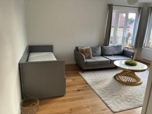 a living room with a couch and a table at Ruddbecksgatan AA in Eskilstuna