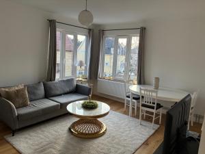 a living room with a couch and a table at Ruddbecksgatan AA in Eskilstuna